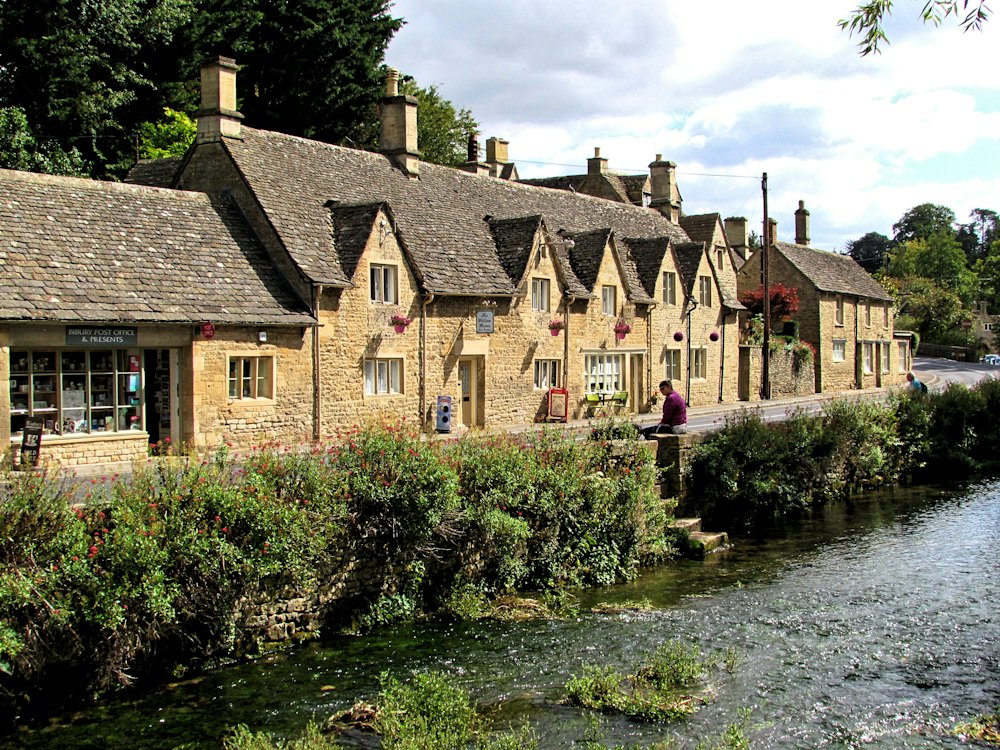 Honey-stone houses along a Cotswold river